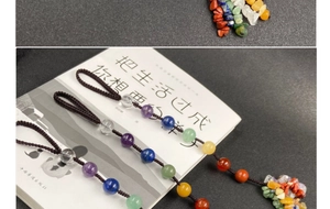 Detailed close-up of handmade woven pendant with seven chakra natural stone beads and tassel