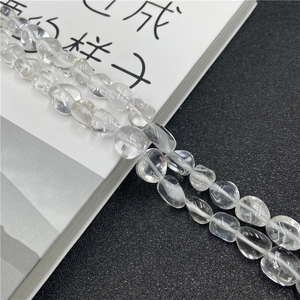 Macro shot of irregular clear quartz crystal beads with natural internal texture detail