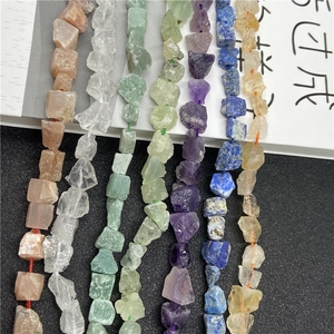 Macro detail of natural tumbled stone beads in various colors for DIY jewelry making