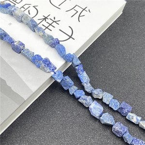 Close-up of irregular deep blue Lapis Lazuli raw stone beads with natural gold veins