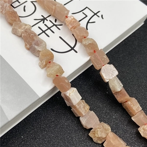 Macro shot of irregular natural orange sunstone raw mineral beads for DIY jewelry making