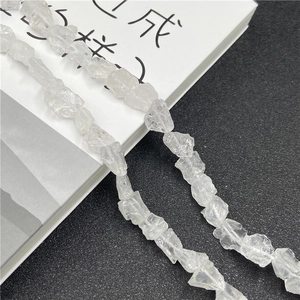 Macro shot of irregular natural clear quartz raw stone beads on a long strand for jewelry