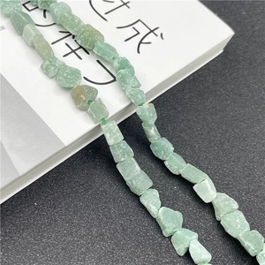 Macro detail of natural irregular light green aventurine raw stone beads for DIY jewelry