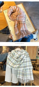 Detail of plaid scarf featuring long tassels and soft cashmere-like warm fabric texture