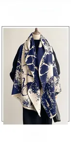 Detailed close-up of blue ink butterfly jacquard scarf with decorative short tassels