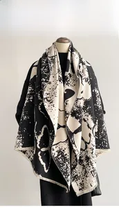 Detail of artistic ink butterfly pattern on thick cashmere shawl with short fringe trim