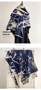 Detail of navy and cream imitation cashmere scarf with butterfly patterns and soft fringe