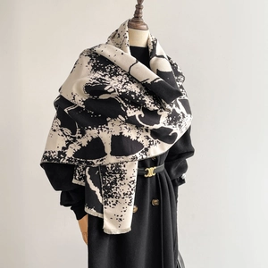 Artistic ink butterfly shawl with black and white ripple patterns and tassel edges