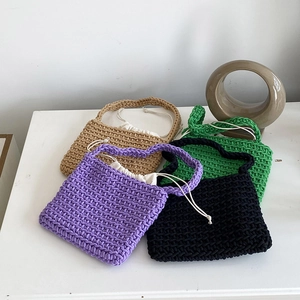 Detailed shot of handmade woven cotton shoulder bags in purple, black, green and khaki