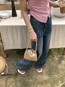 Detail view of khaki cotton rope hand-woven bucket bag with drawstring liner for beach