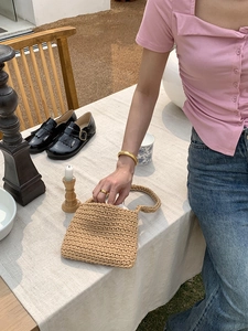 Detailed view of handcrafted woven cotton rope shoulder bag with intricate texture