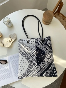 Detailed view of paisley canvas tote bag with black and white bandana pattern and rope handles