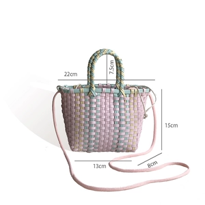 Detail view of woven straw bag with dimensions: 22cm width, 15cm height, 8cm thickness