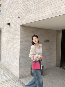 Chic rose pink hand-woven cotton shoulder bag styled with a casual chic outfit