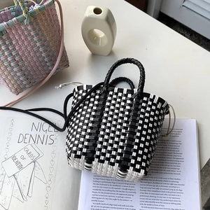 Handwoven black and white checkered crossbody bag with drawstring liner and long shoulder strap