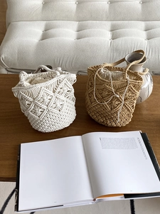 Bohemian style hollow woven bucket bags with inner drawstring liner on wooden table