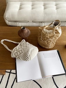Bohemian macrame beach bags in cream and khaki on a rustic wooden table detail