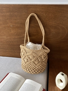 Detail of handmade macrame beach bag with intricate floral weave and drawstring liner