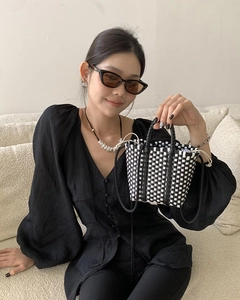 Detail of handmade checkerboard woven tote bag with a white drawstring inner lining bag