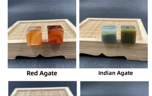 Macro detail of square red agate and Indian agate beads with center holes on bamboo tray