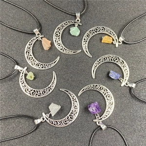 Set of seven moon-shaped pendants with assorted raw semi-precious gemstones and silver metal