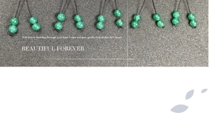 Close-up of polished green agate gourd beads with black cord for DIY jewelry making