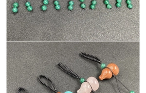Macro shot of assorted natural crystal gourd charms with black woven cords and green beads
