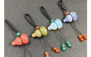 Close-up of assorted natural crystal and agate gourd pendants with braided lanyards