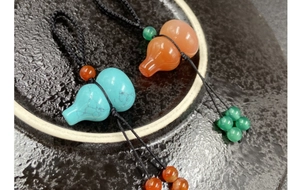 Macro detail of agate and turquoise gourd pendants with handcrafted braided ropes