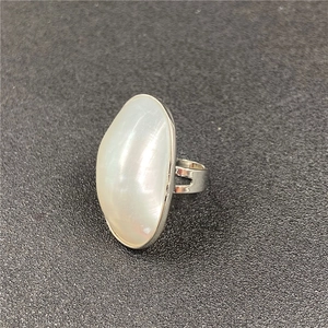 Detailed side view of silver ring featuring a large oval white mother of pearl inlay