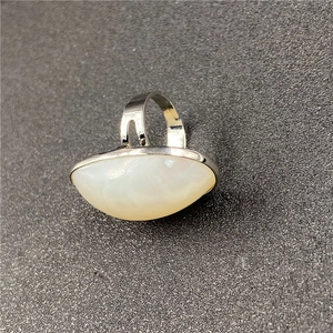 Detailed view of silver open ring featuring a large oval pearlescent mabe gemstone