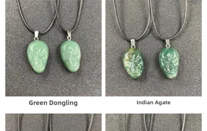 Close-up of Green Aventurine and Indian Agate carved skull pendants with black cord