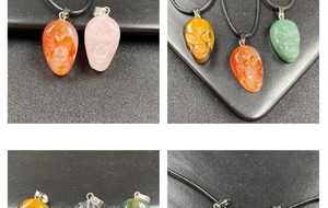 Macro detail of hand-carved crystal skull pendants in various natural gemstones