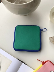 Close-up of a green and blue nylon square storage bag with a durable zipper closure