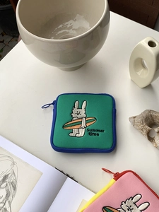 Detailed close-up of a green canvas mini pouch with embroidered cartoon bunny and Summer Time text