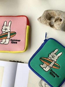 Detail of cartoon bunny embroidery on colorful canvas mini storage bags with Summer time text