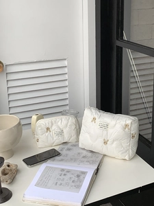 Quilted white nylon organizer bags set with delicate brown rabbit embroidery patterns