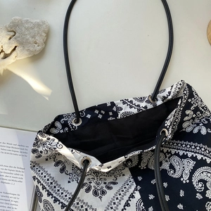Large paisley canvas tote bag with black rope handles and minimalist ethnic print