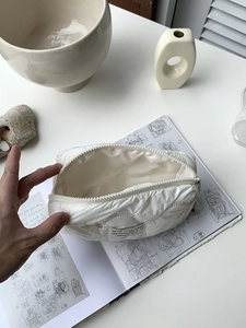 Quilted cloud-style cosmetic bag with zipper opening and spacious interior storage