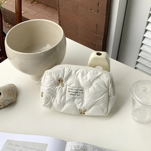 Quilted white travel makeup bag with cute rabbit embroidery and minimalist design