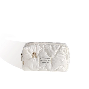 White puffer makeup bag with wavy quilting and cute rabbit embroidery for travel storage
