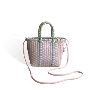 Handwoven crossbody straw bag in macaron colors with top handle and drawstring liner