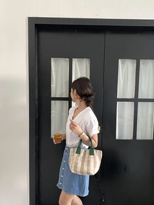 Vertical beige and light brown striped canvas tote bag with dark green top handles