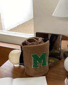 Detail of coffee teddy fleece bucket bag with green towel-embroidered M letter
