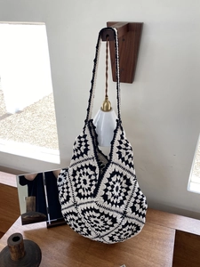 Handmade black and white granny square crochet shoulder bag for women in vintage style