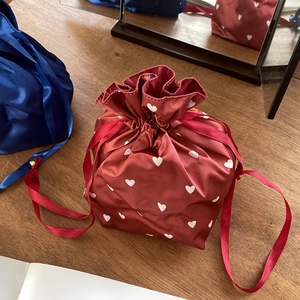 Red heart print satin drawstring bag for travel storage and makeup organization