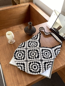 Handmade crochet shoulder bag featuring black and white vintage floral granny squares