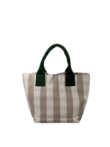 Minimalist canvas tote bag featuring brown stripes and green rope handles on white background