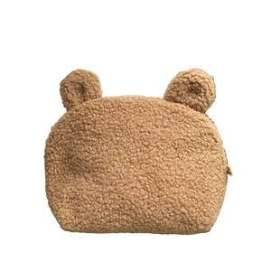 Cute brown teddy bear shaped lamb wool makeup bag with ears on a white background