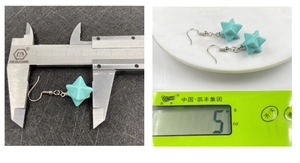 Detail view showing turquoise Merkaba star earrings measured at 2cm with 5g weight